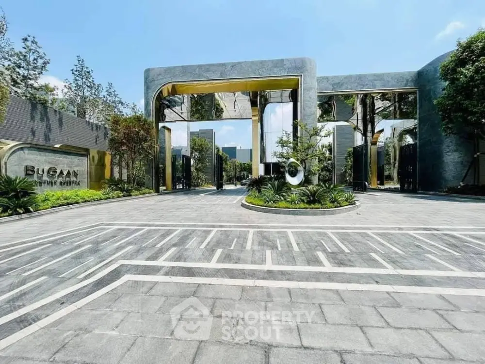 Luxurious modern building entrance with sleek design and lush landscaping