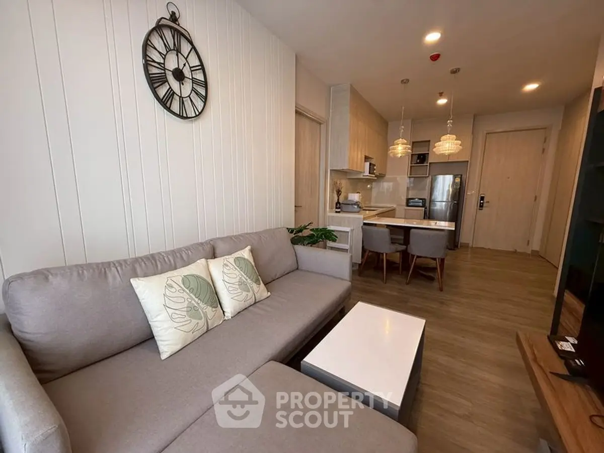 Modern open-layout living room with stylish kitchen and cozy seating area.