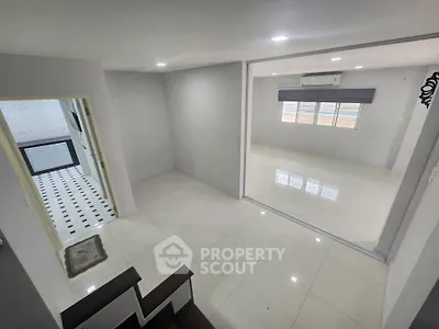 Spacious modern interior with sleek tile flooring and ample natural light, perfect for contemporary living.