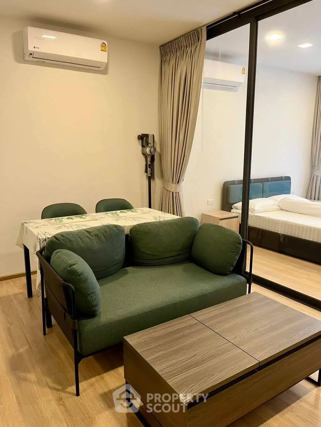 Modern apartment interior with cozy living room and dining area, featuring stylish furniture and elegant decor.