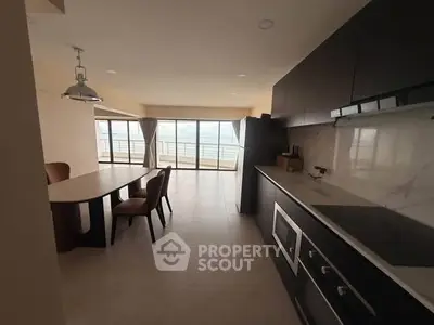 Modern kitchen with open layout and ocean view in luxury apartment