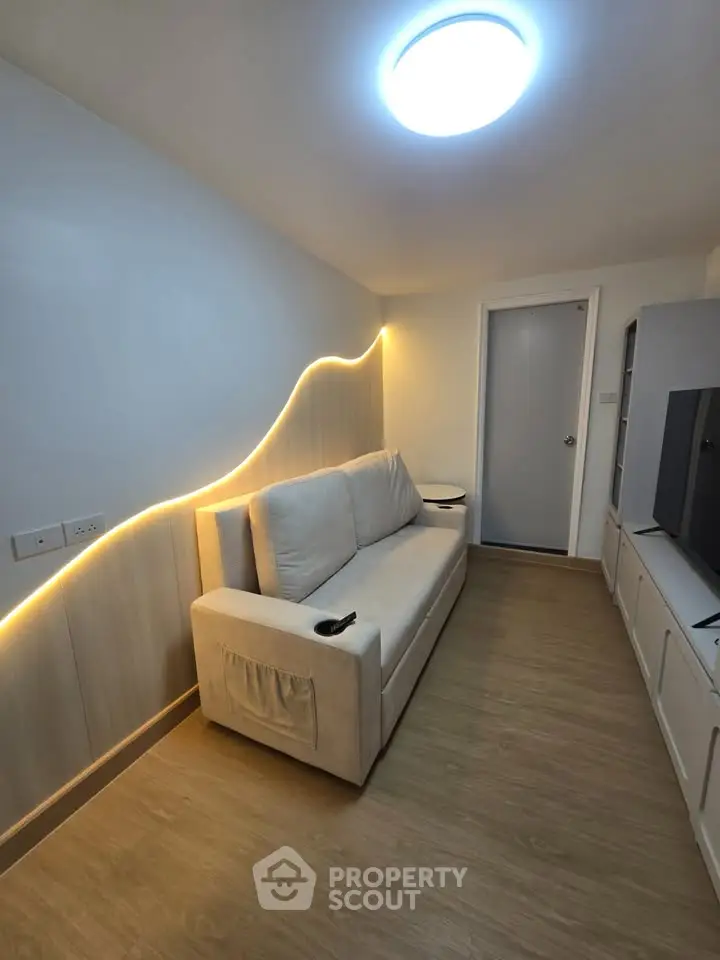 Modern living room with stylish lighting and cozy sofa in a contemporary apartment.