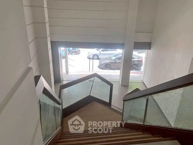 Modern building entrance with stylish staircase and glass railings