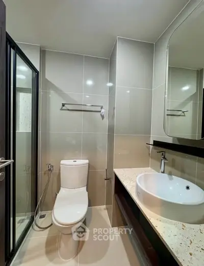 Modern bathroom with sleek fixtures and glass shower enclosure