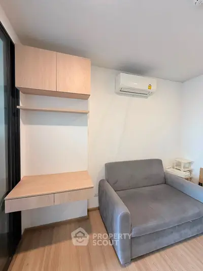 Modern living room with sleek furniture and air conditioning, perfect for comfortable urban living.