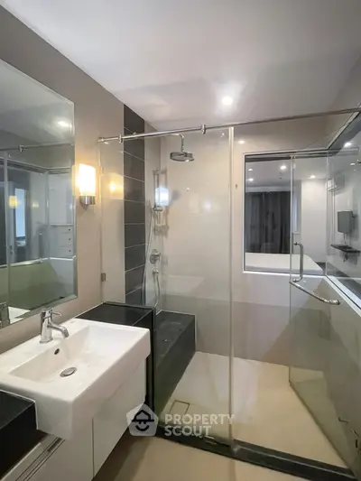 Modern bathroom with glass shower enclosure and sleek fixtures