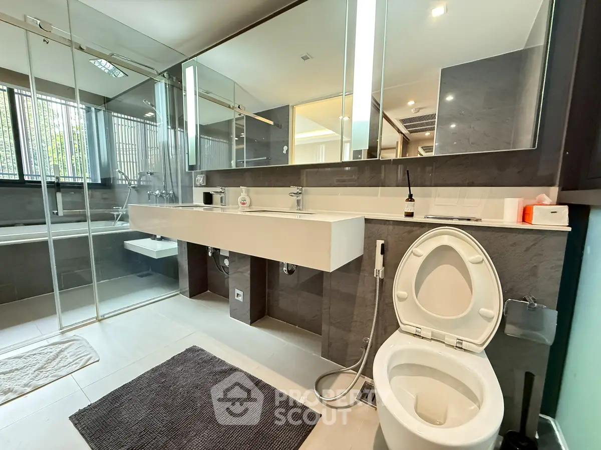Spacious modern bathroom with sleek design and glass shower enclosure.