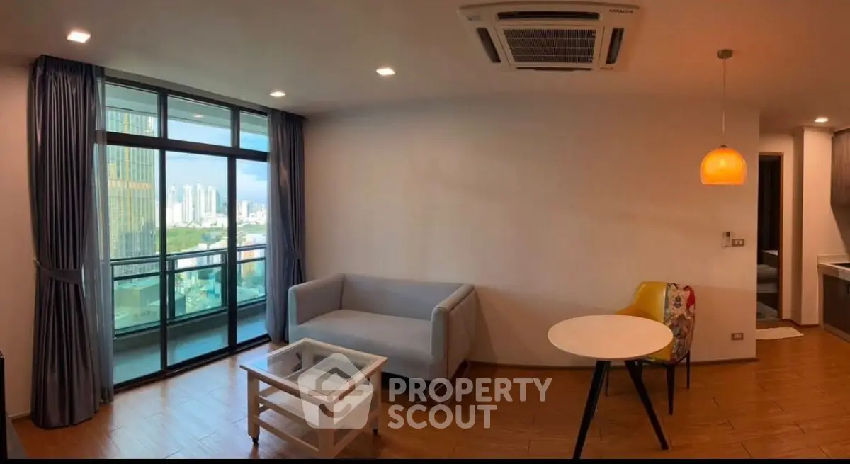 Modern living room with balcony view and stylish furniture in urban apartment