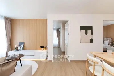 Modern living room with stylish decor and natural light, featuring wooden flooring and contemporary furniture.