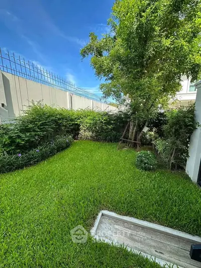 Lush green garden with vibrant grass and trees, perfect for relaxation and outdoor activities.