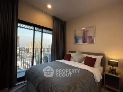Cozy bedroom with city view and balcony access in modern apartment