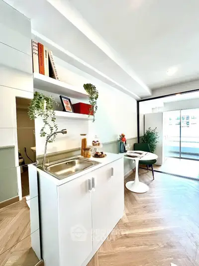 Modern kitchen with sleek design and open layout, featuring a cozy dining area and natural light.