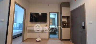 Modern apartment interior with TV, bedroom, and bathroom view