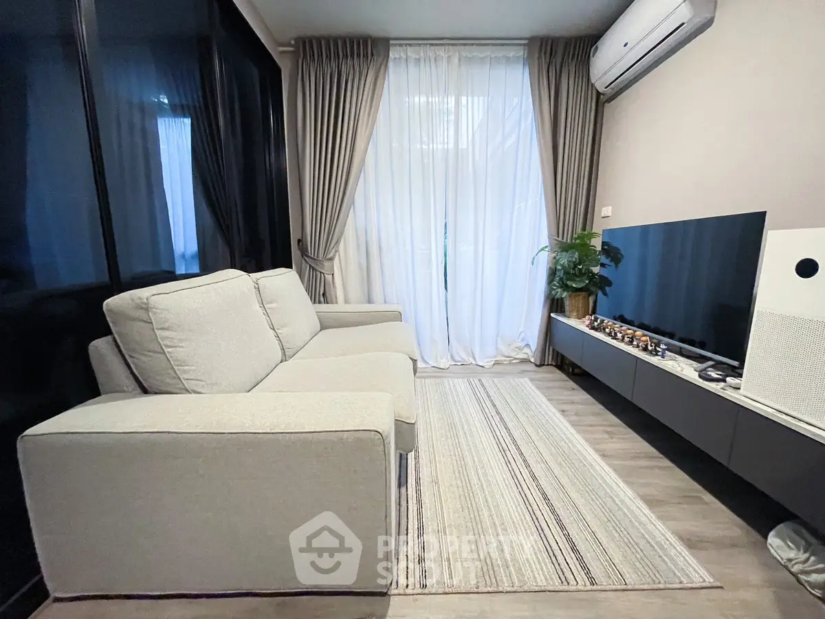 Modern living room with sleek furniture and large window for natural light