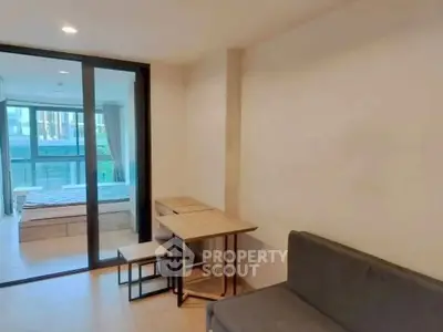 Modern apartment interior with cozy living area and bedroom view