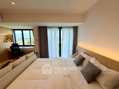 Luxurious bedroom with stunning view and modern decor, featuring a cozy bed and stylish workspace.