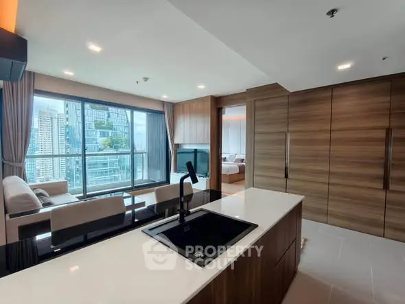 Luxurious open-plan living room with city view and modern kitchen island.
