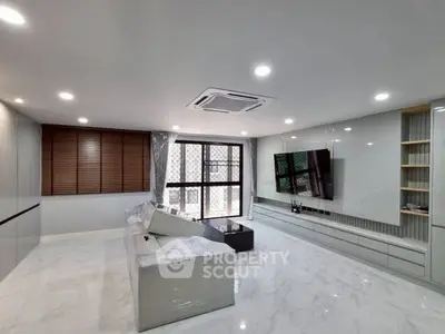 Spacious modern living room with sleek design and large windows