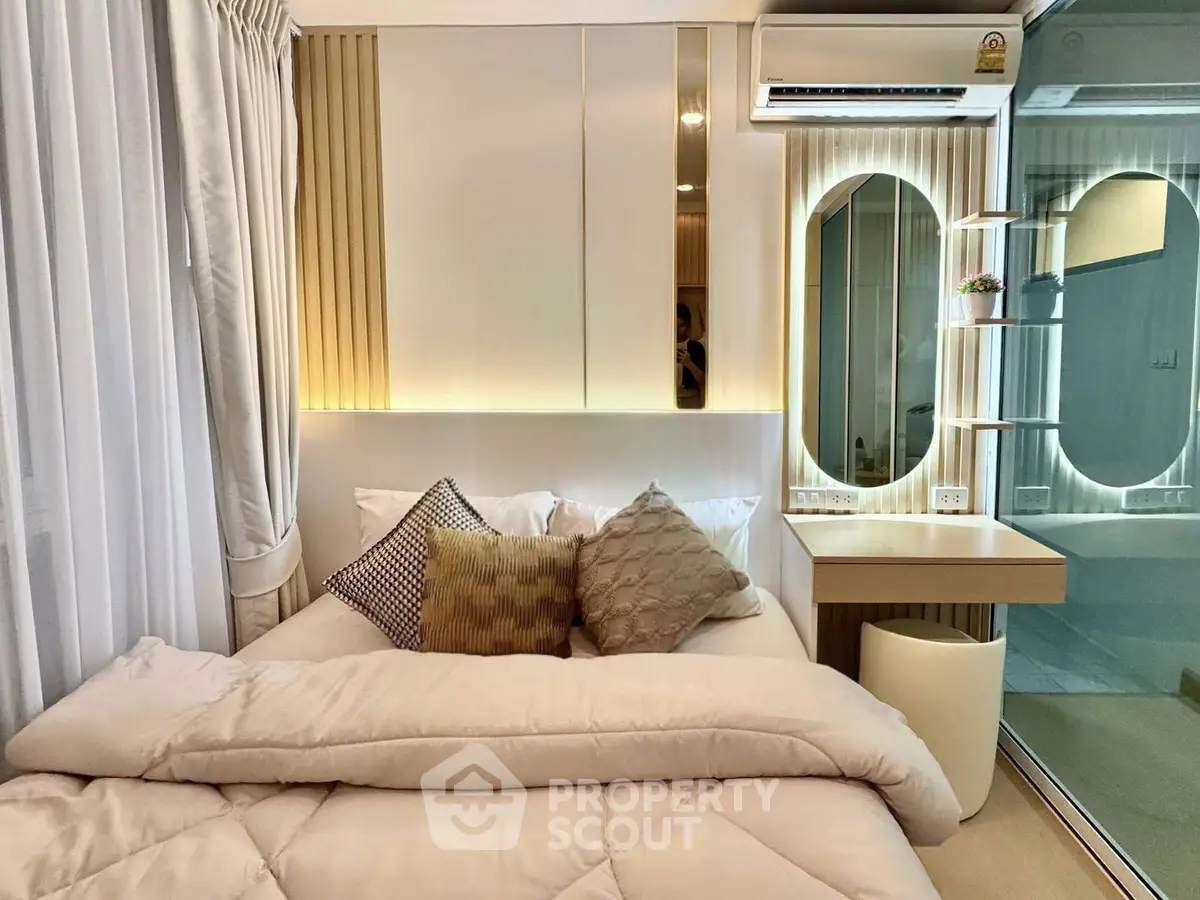Modern bedroom with stylish decor and mirrored accents in a cozy apartment.