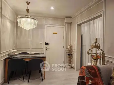 Elegant living room with chandelier and modern decor in a stylish apartment.