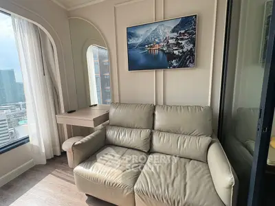 Modern living room with city view, featuring a cozy leather sofa and elegant wall art.