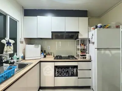 Modern kitchen with gas stove and ample storage space