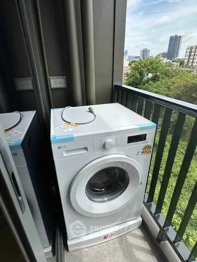 Modern washing machine on a balcony with city view, perfect for urban living convenience.