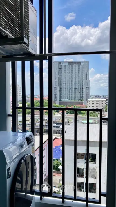 High-rise apartment balcony with washing machine and city view