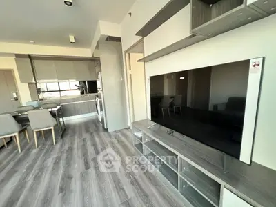 Modern living room with sleek furniture and open kitchen layout