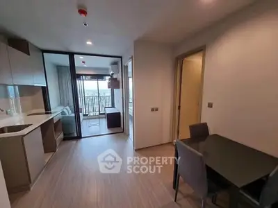 Modern apartment interior with open kitchen and balcony view