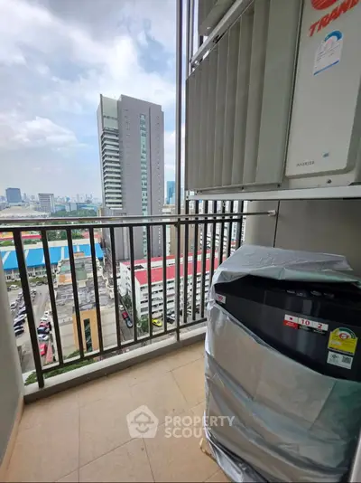High-rise balcony with city view and air conditioning unit, perfect for urban living.