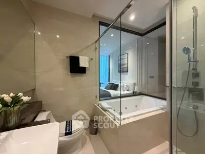 Luxurious bathroom with glass shower and modern bathtub in elegant apartment.