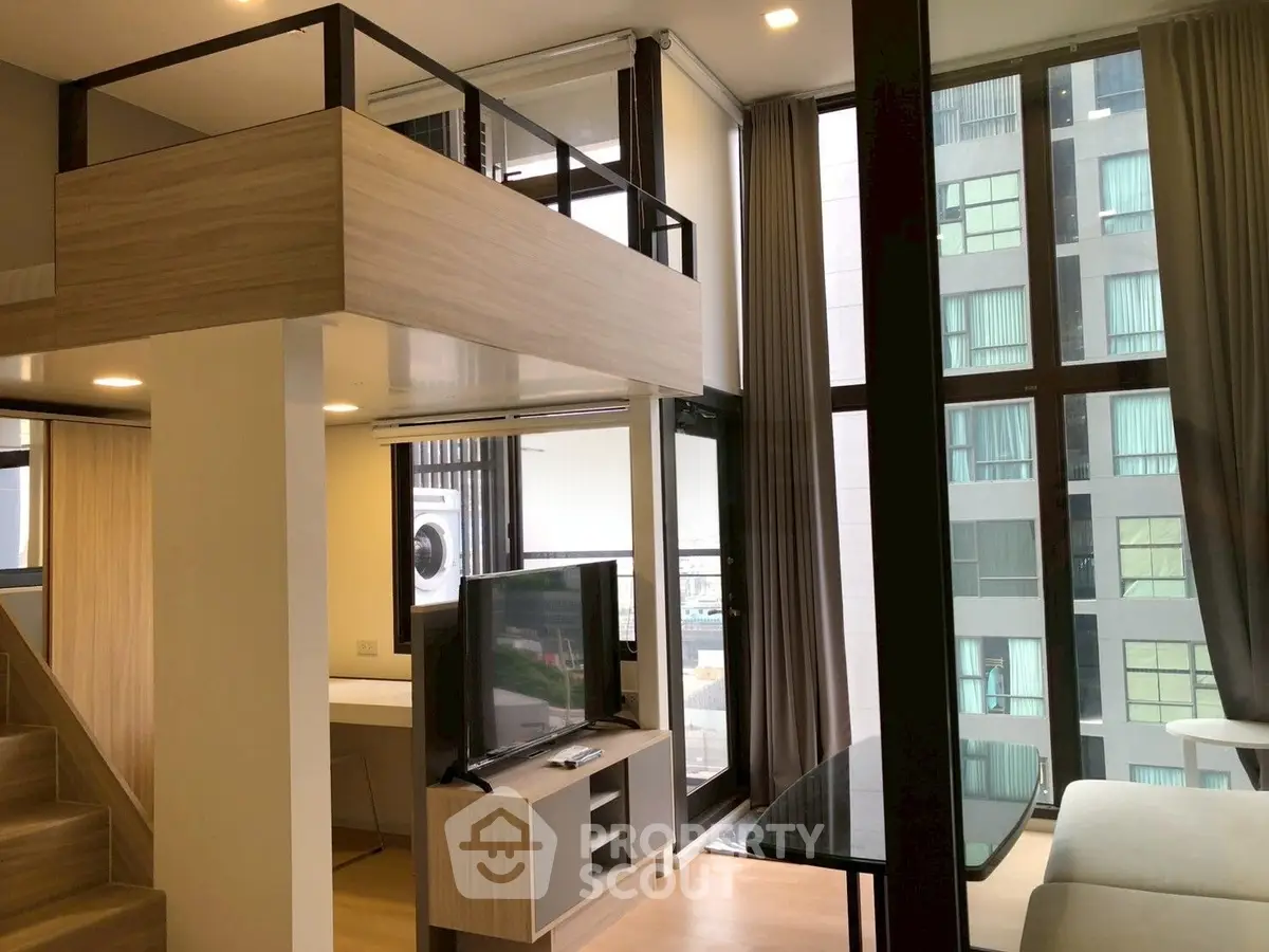 Modern loft apartment with floor-to-ceiling windows and stylish mezzanine design.