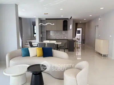 Spacious modern living room with elegant furniture and open kitchen layout