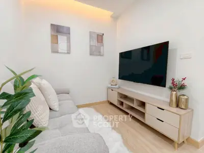 Modern living room with sleek TV setup and cozy decor
