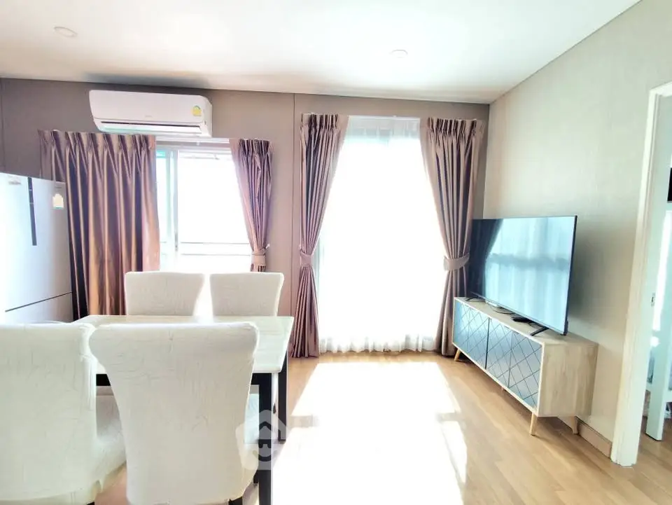 Bright and airy living room with modern decor and large windows.