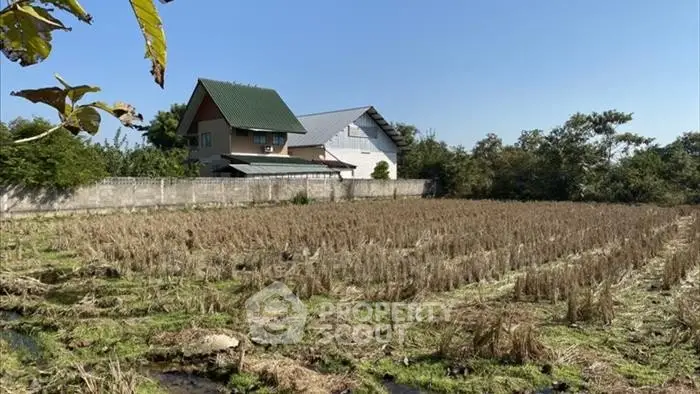 Charming countryside home with expansive field views and lush greenery, perfect for serene living.