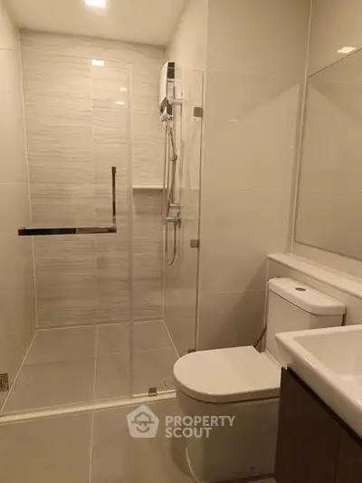 Modern bathroom with glass shower and sleek fixtures