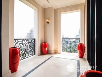 Luxurious balcony with stunning city view and elegant red vases