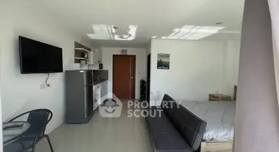 Modern studio apartment with sleek kitchen and cozy living area