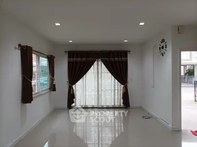 Spacious empty living room with elegant curtains and polished floors