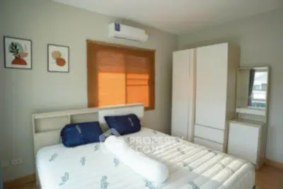 Cozy bedroom with modern decor, featuring a comfortable bed and ample storage space.