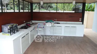 Spacious outdoor kitchen with modern appliances and sleek design, perfect for entertaining guests.
