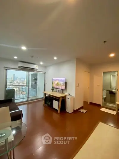 Modern living room with city view and balcony access in a stylish apartment.
