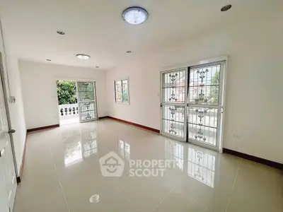 Spacious living room with large windows and balcony access