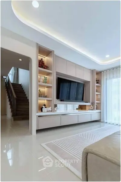 Modern living room with sleek built-in TV unit and elegant lighting