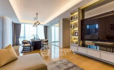 Luxurious modern living room with elegant dining area and large TV setup.