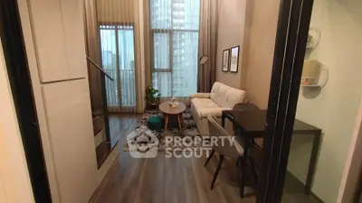 Modern living room with high ceilings and stylish decor in a luxury apartment.