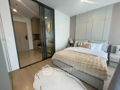 Modern bedroom with stylish decor and cozy ambiance in a contemporary apartment.