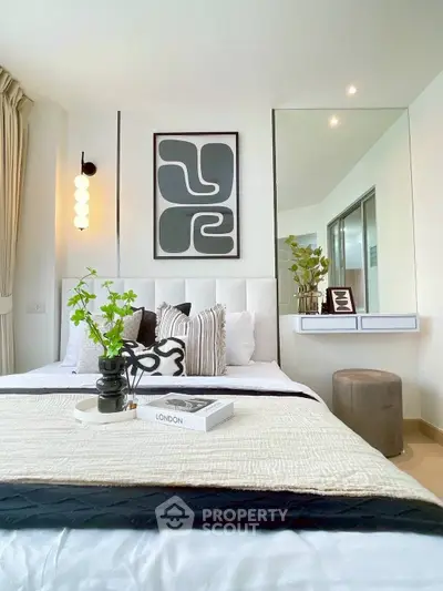 Modern bedroom with stylish decor and large mirror